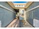 Covered entryway featuring a modern front door, sidelight window, and desert landscaping elements at 26879 N 100Th Ln, Peoria, AZ 85383