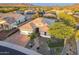 Stunning aerial view of a home with a brick driveway, desert landscaping, and solar panels on the roof at 26879 N 100Th Ln, Peoria, AZ 85383