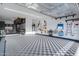 Organized garage with epoxy floor, storage racks, and cabinets for all your needs at 26879 N 100Th Ln, Peoria, AZ 85383
