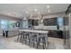 Well-appointed kitchen with modern appliances, a central island with seating, and adjacent dining area at 26879 N 100Th Ln, Peoria, AZ 85383