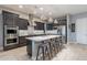 Modern kitchen featuring stainless steel appliances, a large island with seating, and stylish backsplash at 26879 N 100Th Ln, Peoria, AZ 85383