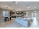 Open concept living area with tile flooring, modern furnishings, kitchen island, and abundant natural light at 26879 N 100Th Ln, Peoria, AZ 85383