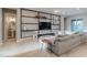 Cozy living room with a large sectional sofa, a decorative wall, and patio access with lots of light at 26879 N 100Th Ln, Peoria, AZ 85383