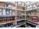 Organized pantry with shelving stocked with various food items and storage containers at 26879 N 100Th Ln, Peoria, AZ 85383