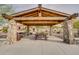 A picnic area with stone supports and wooden beams and a view of nearby homes at 26879 N 100Th Ln, Peoria, AZ 85383