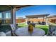 Outdoor living space boasts an extended covered patio, artificial turf, and a well-maintained landscape at 27636 W Runion Dr, Buckeye, AZ 85396