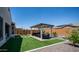 Enjoy outdoor living with a covered patio, artificial turf, and low-maintenance desert landscaping at 27636 W Runion Dr, Buckeye, AZ 85396