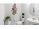 Stylish half bathroom with decorative mirror and modern fixtures at 27636 W Runion Dr, Buckeye, AZ 85396
