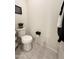 Bathroom features toilet, tiled floors, decor, and a convenient wall-mounted toilet paper holder at 27636 W Runion Dr, Buckeye, AZ 85396