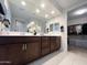Bathroom featuring a double sink vanity, large mirror, and walk-in closet at 27636 W Runion Dr, Buckeye, AZ 85396
