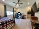 Comfortable bedroom with large window, ceiling fan, and cozy carpet at 27636 W Runion Dr, Buckeye, AZ 85396