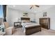 Cozy bedroom with a wooden bed frame, soft lighting, and neutral decor at 27636 W Runion Dr, Buckeye, AZ 85396