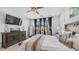Bedroom featuring a large window, dark wood furniture, and bright natural light at 27636 W Runion Dr, Buckeye, AZ 85396