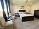 Bedroom with dark furniture, stylish décor, and plenty of natural light at 27636 W Runion Dr, Buckeye, AZ 85396