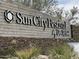 Sun City Festival by Del Webb community sign with stacked stone base and desert landscaping at 27636 W Runion Dr, Buckeye, AZ 85396