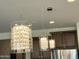 Contemporary dining area showcases modern pendant lighting and kitchen cabinets at 27636 W Runion Dr, Buckeye, AZ 85396
