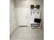 Entryway with white hall tree bench, shoe storage, tile flooring, and hooks for hanging accessories at 27636 W Runion Dr, Buckeye, AZ 85396