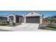 Charming single-story home featuring a well-manicured front yard and a two-car garage at 27636 W Runion Dr, Buckeye, AZ 85396