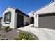 Charming home featuring a two-car garage, beautiful landscaping, and a welcoming arched entryway at 27636 W Runion Dr, Buckeye, AZ 85396