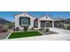Beautiful home exterior featuring desert landscaping, artificial turf, and a two-car garage at 27636 W Runion Dr, Buckeye, AZ 85396