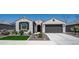 Charming single-story home featuring a well-maintained front yard, a two-car garage, and desert landscaping at 27636 W Runion Dr, Buckeye, AZ 85396