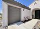 Attached two car garage with seating on the walkway and desert landscaping at 27636 W Runion Dr, Buckeye, AZ 85396