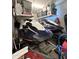Garage interior with two jet skis on a trailer and storage shelves at 27636 W Runion Dr, Buckeye, AZ 85396