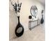 Hallway with decorative vases, a mirror, and a modern console table at 27636 W Runion Dr, Buckeye, AZ 85396