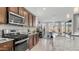 Well-equipped kitchen with granite countertops, stainless steel appliances, and an open view to the dining area at 27636 W Runion Dr, Buckeye, AZ 85396