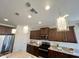 Modern kitchen features stainless steel appliances, granite counters, and stylish pendant lighting at 27636 W Runion Dr, Buckeye, AZ 85396