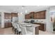 Modern kitchen features a large island with seating, granite countertops, and stainless steel appliances at 27636 W Runion Dr, Buckeye, AZ 85396