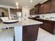 Spacious kitchen featuring a large island with granite countertops and plenty of seating at 27636 W Runion Dr, Buckeye, AZ 85396