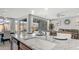 Kitchen island with granite countertop, stainless steel dishwasher, and seating for casual dining at 27636 W Runion Dr, Buckeye, AZ 85396