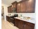 Kitchen with granite countertops, stainless steel appliances, and wooden cabinets at 27636 W Runion Dr, Buckeye, AZ 85396