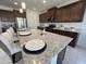 Kitchen island with white countertops and stylish seating at 27636 W Runion Dr, Buckeye, AZ 85396