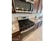 Modern kitchen features a stainless steel gas range, granite countertops, and ample cabinet space at 27636 W Runion Dr, Buckeye, AZ 85396