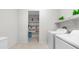 Bright laundry room with shelving and modern appliances for added convenience at 27636 W Runion Dr, Buckeye, AZ 85396