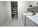 Clean and spacious laundry room with access to a pantry for extra storage at 27636 W Runion Dr, Buckeye, AZ 85396