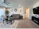 Inviting living room featuring neutral tones, modern decor, and a seamless flow to other rooms at 27636 W Runion Dr, Buckeye, AZ 85396