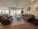 Expansive living room with sliding glass doors leading to a beautifully landscaped backyard and patio area at 27636 W Runion Dr, Buckeye, AZ 85396