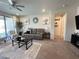 Inviting living room featuring neutral tones, modern decor, and a seamless flow to other rooms at 27636 W Runion Dr, Buckeye, AZ 85396
