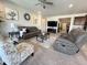 Open-concept living room with plush sofas, stylish decor, and a seamless transition to other living spaces at 27636 W Runion Dr, Buckeye, AZ 85396