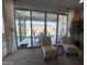 Cozy living room with sliding glass doors leading to an outdoor seating area and landscaped backyard at 27636 W Runion Dr, Buckeye, AZ 85396
