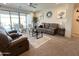 Cozy living room with ample seating and a view of the patio at 27636 W Runion Dr, Buckeye, AZ 85396
