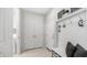 Hallway with a built-in mudroom bench, coat hooks, and storage, conveniently located near the laundry area at 27636 W Runion Dr, Buckeye, AZ 85396