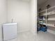 Spacious pantry with tile floors, storage shelving, and large freezer at 27636 W Runion Dr, Buckeye, AZ 85396