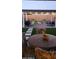 A patio with a covered area, string lights, grill, and seating area with stepping stones at 27636 W Runion Dr, Buckeye, AZ 85396
