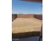 Backyard view of a fenced, flat and bare yard with rocky landscaping at 284 W Settlers Trl, Casa Grande, AZ 85122