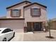 Two-story home with a front-facing two-car garage and rock landscaping at 284 W Settlers Trl, Casa Grande, AZ 85122