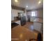 A well-lit kitchen featuring stainless steel appliances, white cabinets, and tile flooring at 284 W Settlers Trl, Casa Grande, AZ 85122